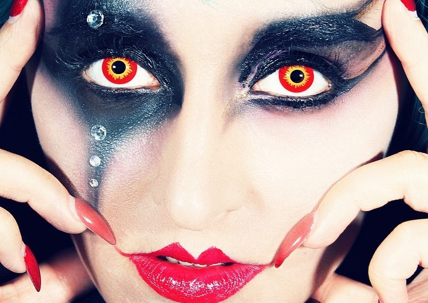 Woman with face paint and red nails